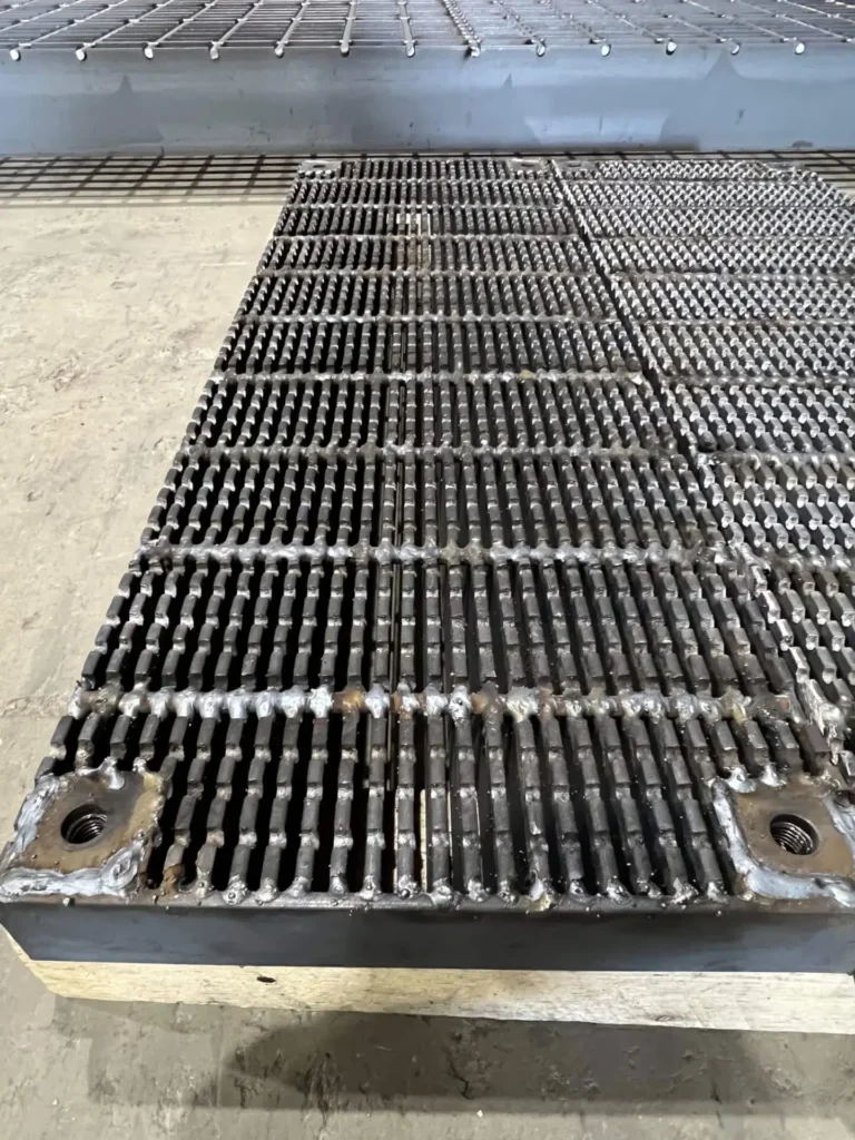 Serrated heel safe grate with lugs